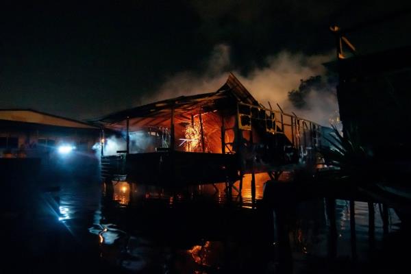 Labuan Fire and Rescue Department perso<em></em>nnel work to put out the fire at the water village of Patau-Patau 2 February 11, 2024. — Bernama pic